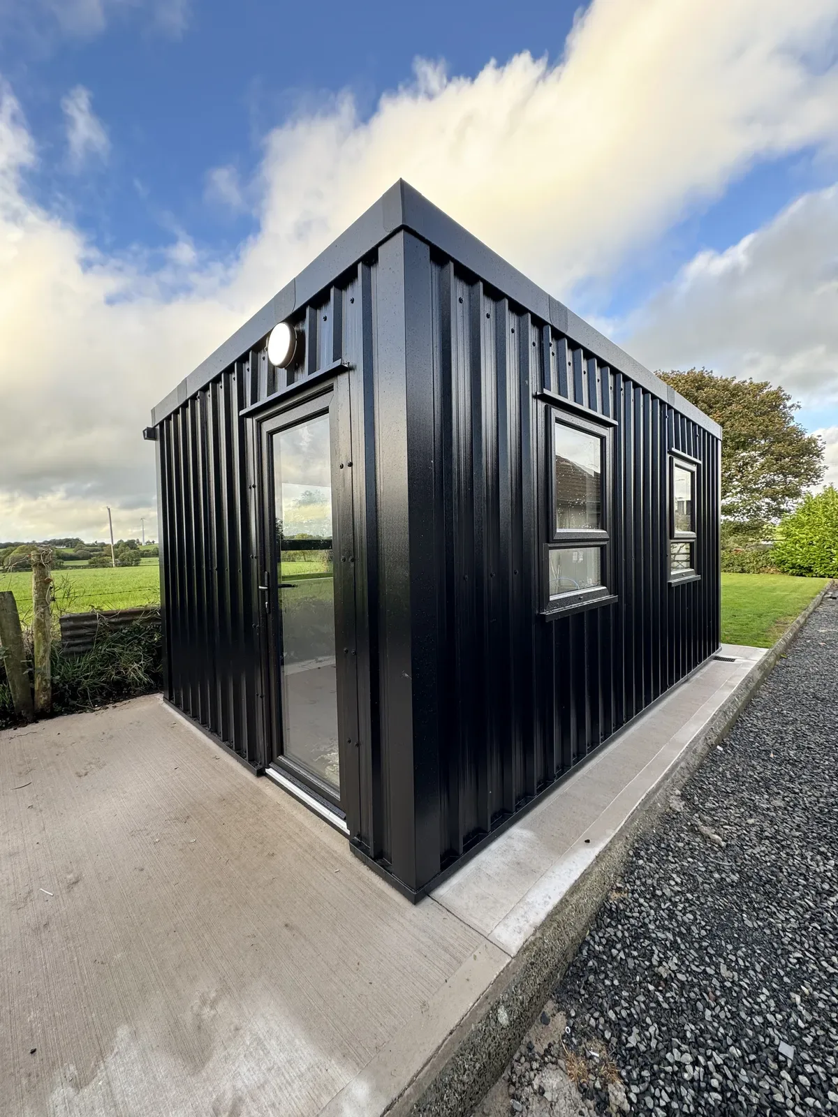Black steel-clad garden room with glazed door